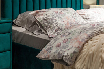 Beautiful linens on a comfortable stylish bed. Interior design and recreation. Close-up.