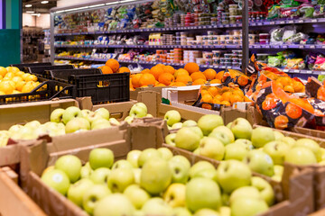 Vegetable department in the supermarket. Fresh fruit on the counter.
