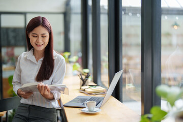 Portrait of an Asian woman reading a book during her lunch break