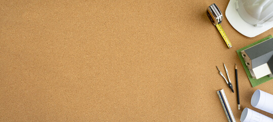 Flat lay top view desk work table with Blueprint drawing,Yellow Helmet,architect design stationary...