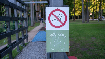 the beginning of the adventure trail. Gate with sign, no shoes with bare feet.