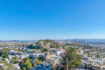 Dense apartment buildings and townhouses around the hill in the middle at San Francisco, CA