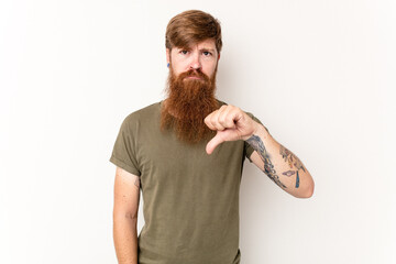 Young caucasian red-haired man isolated on white background showing a dislike gesture, thumbs down....