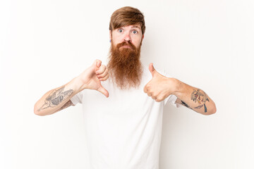 Young caucasian red-haired man isolated on white background showing thumbs up and thumbs down,...