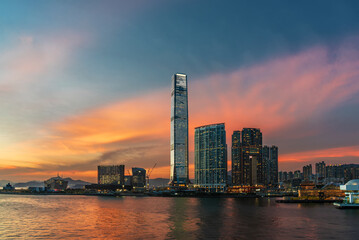 skyscraper, skyline and harbor of Hong Kong city under sunset