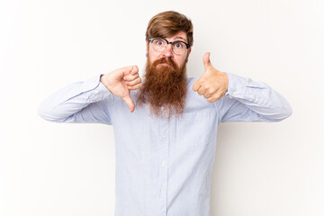 Young caucasian red-haired man isolated on white background showing thumbs up and thumbs down,...