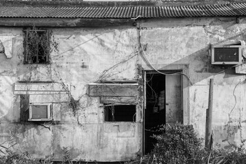 Exterior of abandoned house in black and white