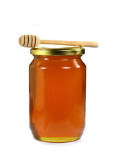 Jar with organic honey isolated on white. Glass jar full of honey and dipper isolated on white background.