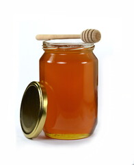 Jar with organic honey isolated on white. Glass jar full of honey and dipper isolated on white background.