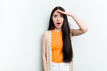 Fototapeta premium Young caucasian woman isolated on white background shouts loud, keeps eyes opened and hands tense.