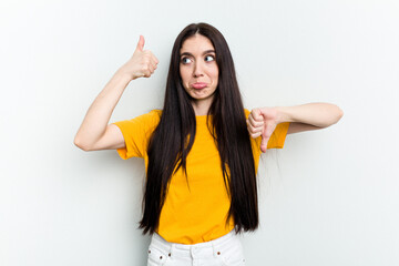 Young caucasian woman isolated on white background showing thumbs up and thumbs down, difficult choose concept