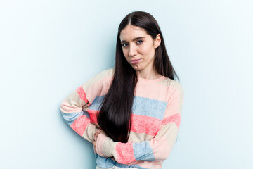 Obraz premium Young caucasian woman isolated on blue background having a liver pain, stomach ache.