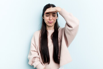Young caucasian woman isolated on blue background touching temples and having headache.