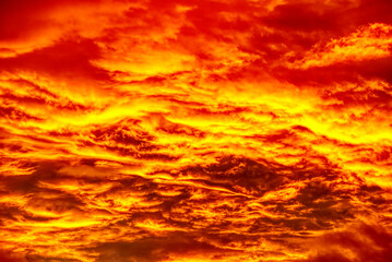 Swirling evening clouds illuminated by the setting sun