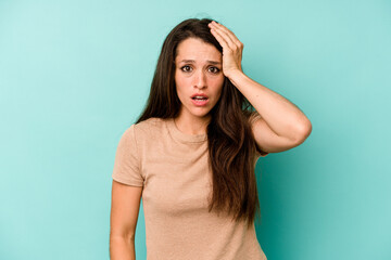 Young caucasian woman isolated on blue background being shocked, she has remembered important...