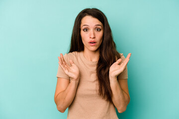 Young caucasian woman isolated on blue background surprised and shocked.