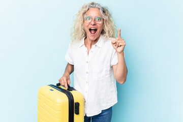 Young traveler man holding a suitcase isolated on white background having an idea, inspiration concept.