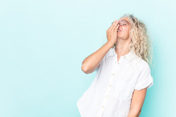 Middle age caucasian woman isolated on blue background laughing happy, carefree, natural emotion.