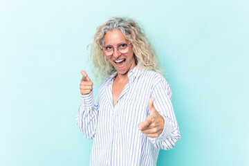 Middle age caucasian woman isolated on blue background cheerful smiles pointing to front.