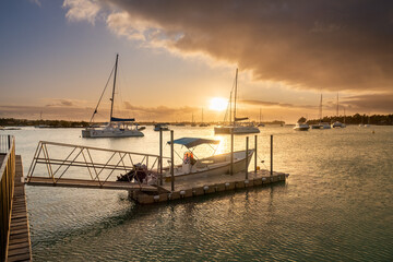 Fototapeta na wymiar Sunset in Mauritius Grand Baie harbor with boats in foreground