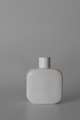 Perfume bottle on a white background. Cosmetics, perfumes, creams - product photography. Beautiful and neat bottle of perfume