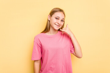 Young caucasian girl isolated on yellow background showing a mobile phone call gesture with fingers.