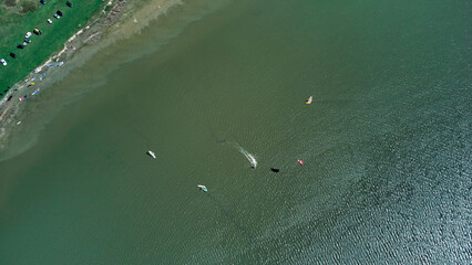 Windsurfing camp on a lake shore.