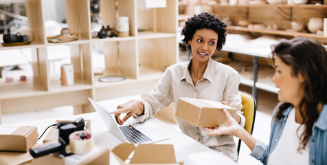 Female online store owners preparing some orders for shipping