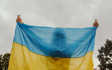 the girl is holding the flag of Ukraine. the concept of patriotism