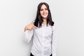 Telemarketer caucasian woman working with a headset isolated on white background person pointing by hand to a shirt copy space, proud and confident