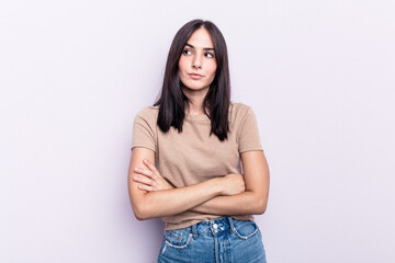 Young caucasian woman isolated on pink background dreaming of achieving goals and purposes