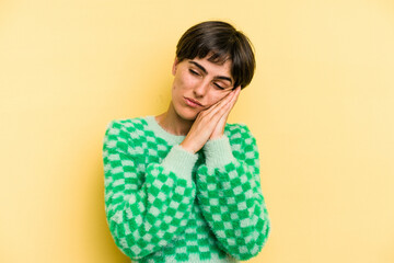 Young caucasian woman with a short hair cut isolated yawning showing a tired gesture covering mouth with hand.