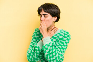 Young caucasian woman with a short hair cut isolated suffers pain in throat due a virus or infection.