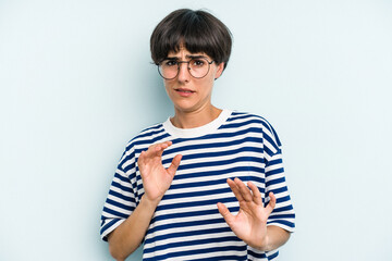 Young caucasian woman with a short hair cut isolated rejecting someone showing a gesture of disgust.