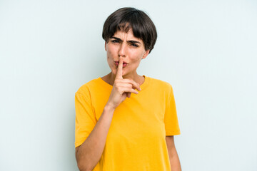 Young caucasian woman with a short hair cut isolated keeping a secret or asking for silence.
