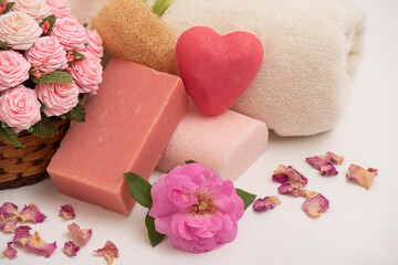 Damask rose flowers and soap isolated on white background.