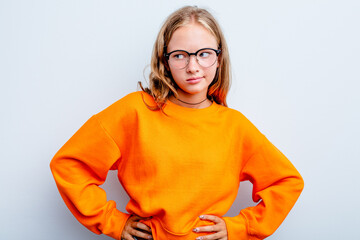Caucasian teen girl isolated on blue background dreaming of achieving goals and purposes