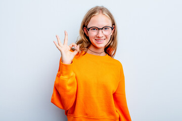 Caucasian teen girl isolated on blue background cheerful and confident showing ok gesture.