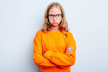 Caucasian teen girl isolated on blue background blows cheeks, has tired expression. Facial...
