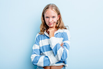 Caucasian teen girl isolated on blue background unhappy looking in camera with sarcastic expression.