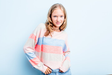Caucasian teen girl isolated on blue background