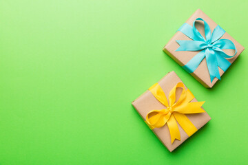 Holiday present box over colored background, top view