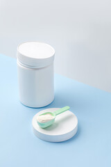 Jar and measure spoon with collagen or protein powder. Skin care beauty supplement. Copy space