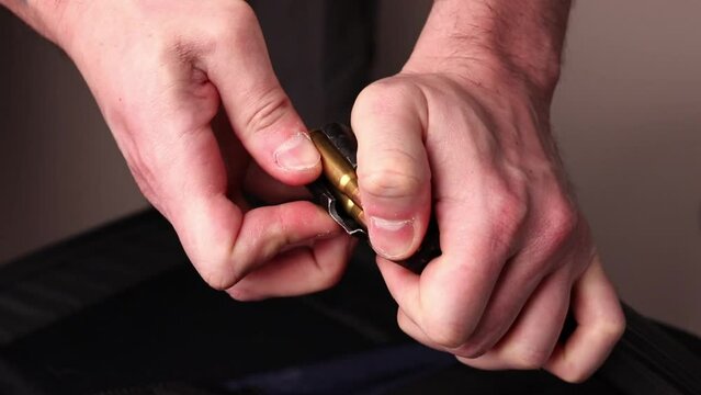 Male hands loading Kalashnikov assault rifle magazine with cartridges. Load magazine with bullets 7.62 caliber for ak 47 closeup