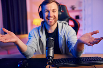 Man in headphones and with microphone is live on the stream