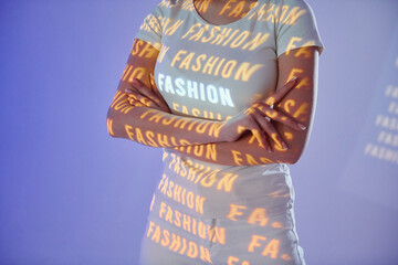 Close up view. With woman word. Beautiful young woman is in projector neon lights in the studio