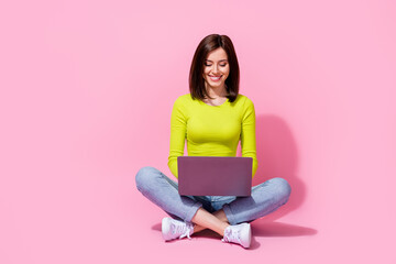 Photo of successful specialist lady sit use netbook colleagues communication isolated on pink color...