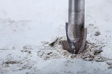Ceramic drill bit make holes in concrete wall with industrial drill. Building work industry.