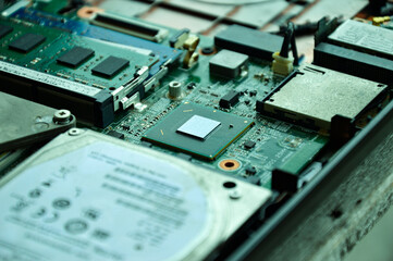 Close-up of a part of a computer motherboard, with many IC chips visible.