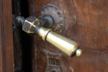 Metal decorative handles. Metal decorative handle on old massive entrance doors.